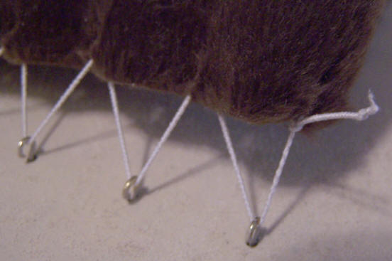 Photo showing the tent covering attached to the hooks in the tabernacle kit.