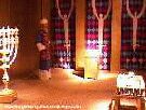Color photo of recreation of tabernacle, view of inside the Holy Place, showing a priest, the lampstand, the table of shewbred, and the altar of incense from 'Great Passion Play' copyright Elna M. Smith Foundation.